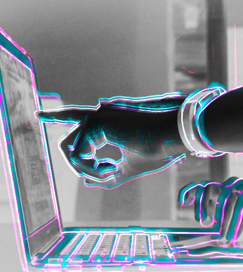 A digitally altered photo of two people reviewing content on a laptop